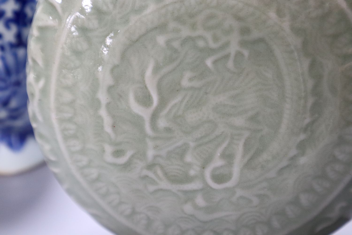 A Chinese blue and white moon flask, a Chinese celadon glazed moon flask and a famille verte baluster vase, tallest 21cm